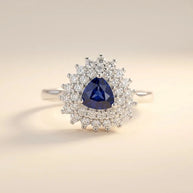 Trillion Cut ring with a blue trillion-cut stone in a double sunburst halo, S925 sterling silver by Maadin Artistry